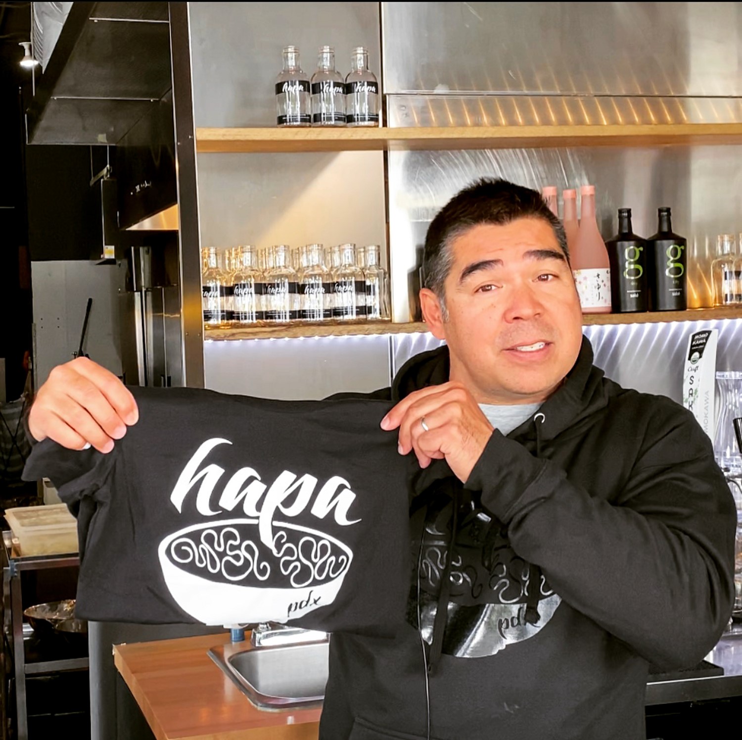 Mike showing off a Hapa Shirt while wearing a Hapa PDX Black-on-Black Hoodie